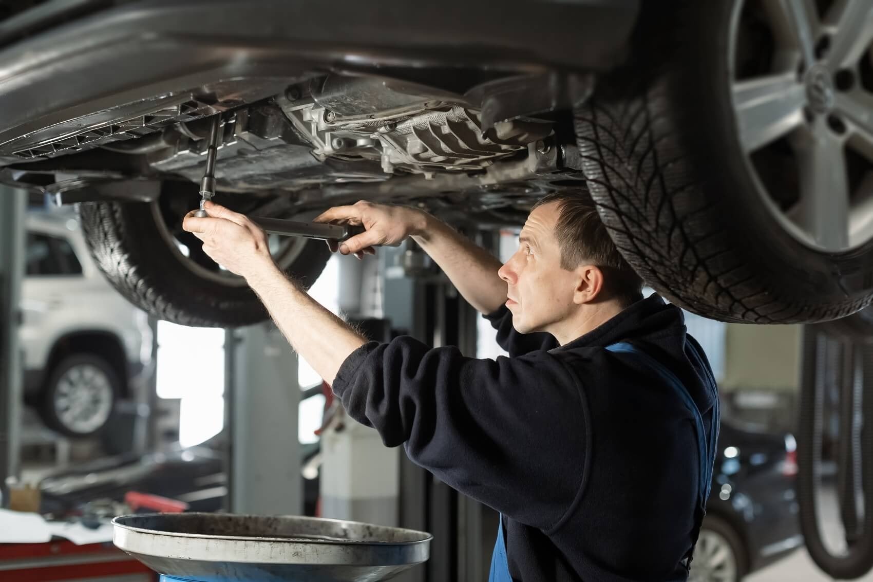 image of a mechanic working on a car
