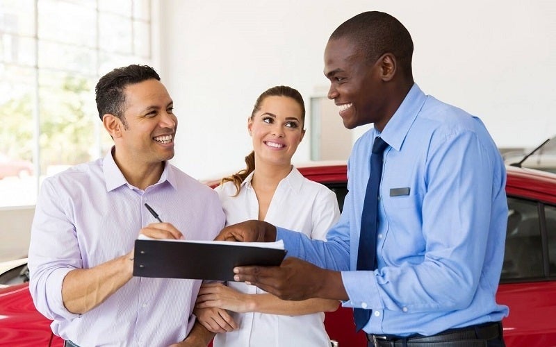 image of a couple with a salesman standing next to them